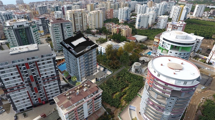 Просторная квартира планировкой 1+1 в строящемся доме в районе Махмутлар