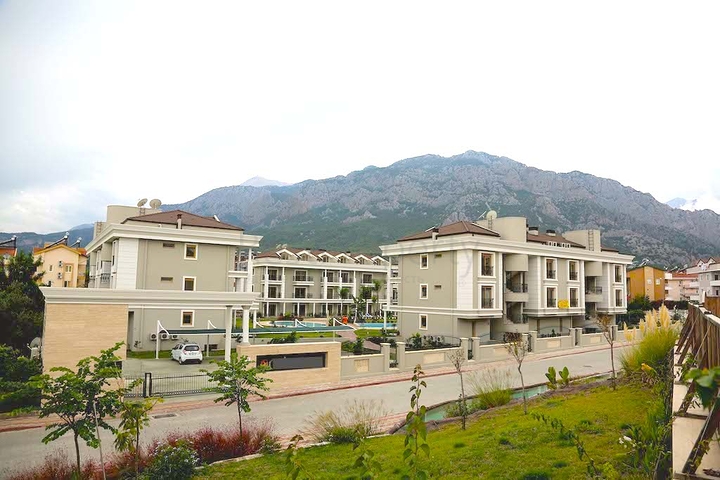 Новый жилой комплекс в живописной долине среди хвойного леса с видом на горы