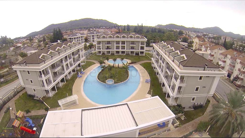 Новый жилой комплекс в живописной долине среди хвойного леса с видом на горы