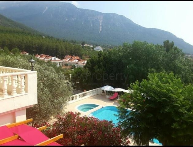 Дом в горном ущелье с зеленым садом