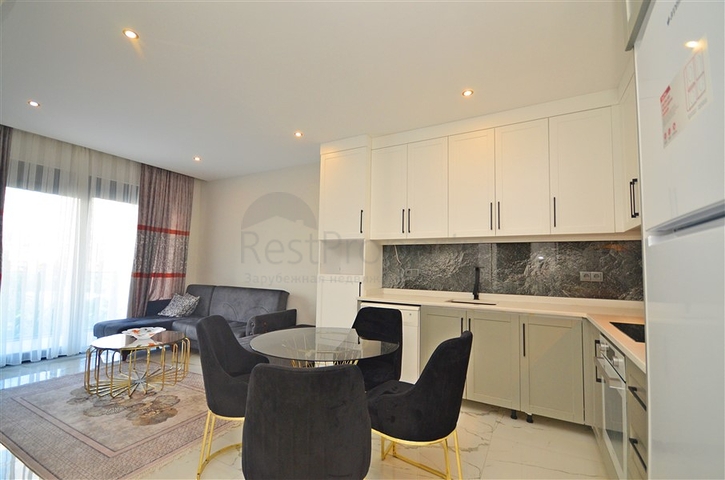 Двухкомнатная квартира в живописном районе Алании и пешей доступности к морю