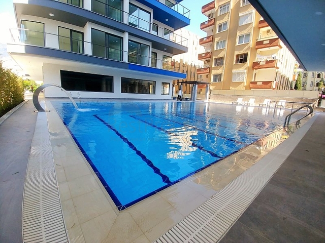 Апартаменты 2+1 на первой береговой линии в Махмутларе