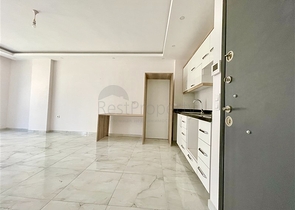 Просторная новая двухкомнатная квартира в Махмутларе