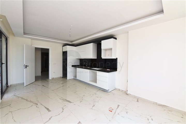 Двухкомнатная квартира с панорамным видом на горы в районе Махмутлар