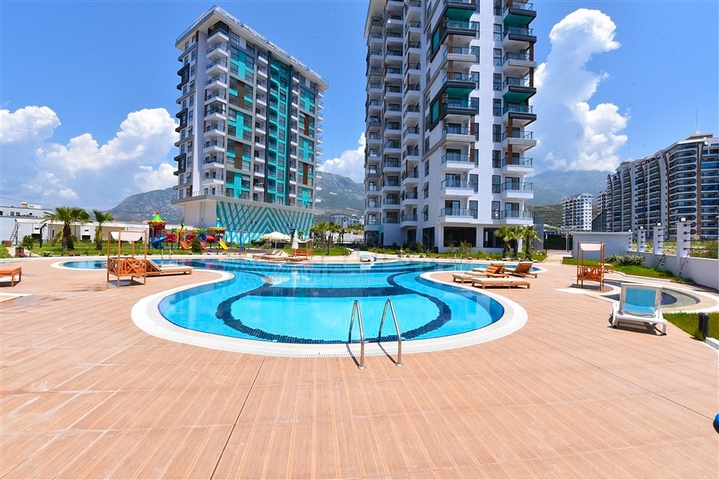 Квартира планировки 1+1 в новом комплексе в районе Махмутлар