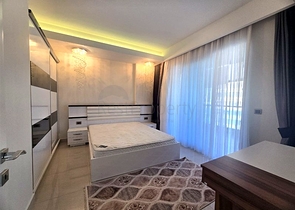 Светлая квартира 1+1 на высоком этаже в районе Махмутлар